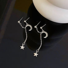 Load image into Gallery viewer, A pair of solid stainless steel earrings featuring a moon and star design connected by a delicate chain. The earrings measure 6cm in length, adding a touch of celestial charm to any outfit.
