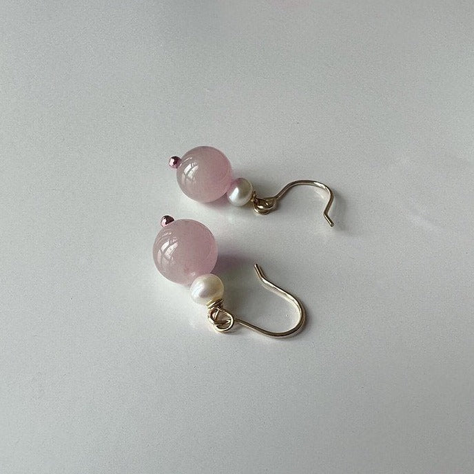 18K gold plated dangle earrings with 8mm rose quartz beads and 3mm pearls, perfect for adding a touch of romance and sophistication to any outfit.