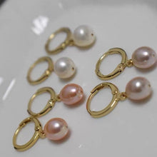 Load image into Gallery viewer, Hoop earrings plated with 18K gold, featuring 5-6mm AAA oval light pearls in white, peach, and purple colors, with a lever back huggie style.
