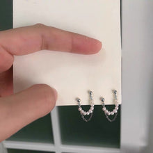 Load image into Gallery viewer, Image of a pair of hypoallergenic surgical steel double piercing earrings featuring 3mm mini button pearls, adding a touch of elegance and style to any outfit.
