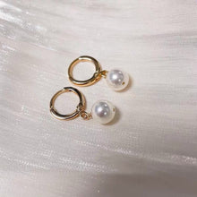 Load image into Gallery viewer, 18K gold plated huggie earrings with off-round AAA-grade 7mm freshwater pearls, perfect for adding a touch of elegance to any outfit.
