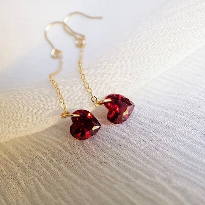 18K gold plated or surgical steel dangle earrings with 6mm cubic zirconia red hearts, perfect for adding a touch of romance and glamour to any outfit.