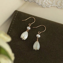 Load image into Gallery viewer, 18K gold plated dangle earrings featuring 8-9mm natural mother of pearl white champaca flowers, perfect for adding elegance and sophistication to any outfit.
