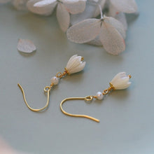 Load image into Gallery viewer, 18K gold plated dangle earrings featuring 8-9mm natural mother of pearl white champaca flowers, perfect for adding elegance and sophistication to any outfit.
