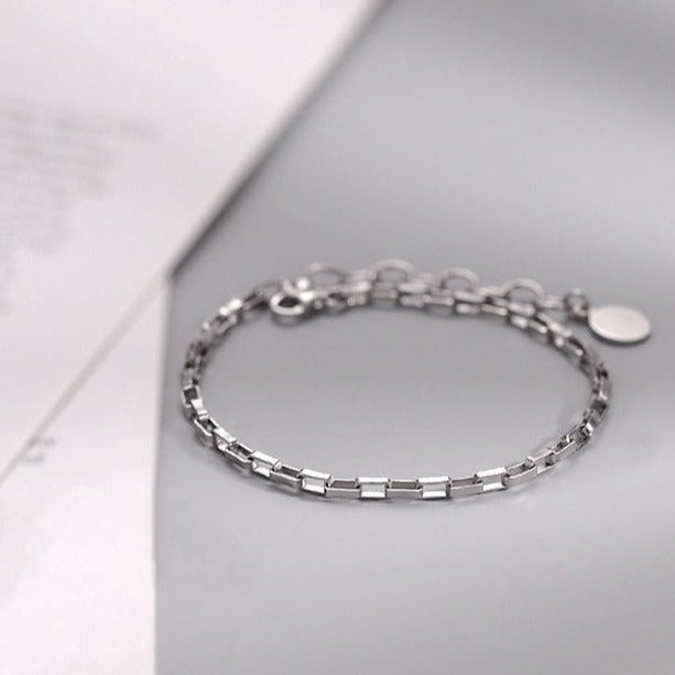 A dainty chain link bracelet with 4x2mm links, available in 6, 7, and 8 inches with an extender, offering a delicate and minimalist style.