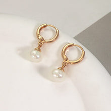 Load image into Gallery viewer, 18K gold-plated hoop earrings with 4mm half-drilled button pearls. Huggie style for comfortable all-day wear, adding a classic accent to any outfit.
