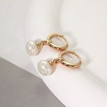 Load image into Gallery viewer, 18K gold-plated hoop earrings with 4mm half-drilled button pearls. Huggie style for comfortable all-day wear, adding a classic accent to any outfit.
